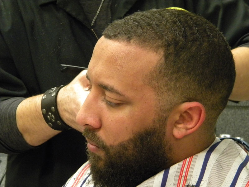 photo of barber doing a fade haircut